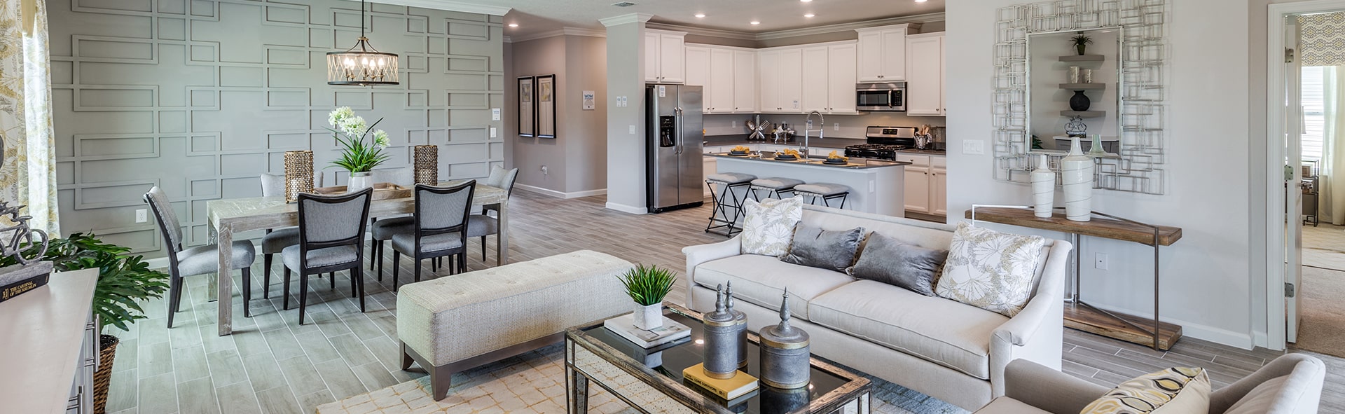 trevi model home interior with a statement wall in dining room and white shaker kitchen cabinets and an island