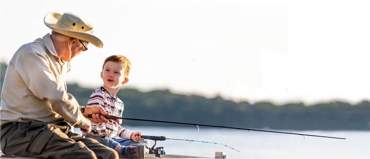 Grandfather and grandson fishing at Tributary
