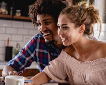 Couple on Computer Looking at Digital Home Buying Guide at Tributary