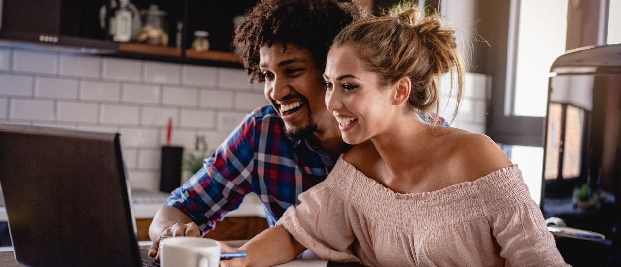 Couple on Computer Looking at Digital Home Buying Guide at Tributary