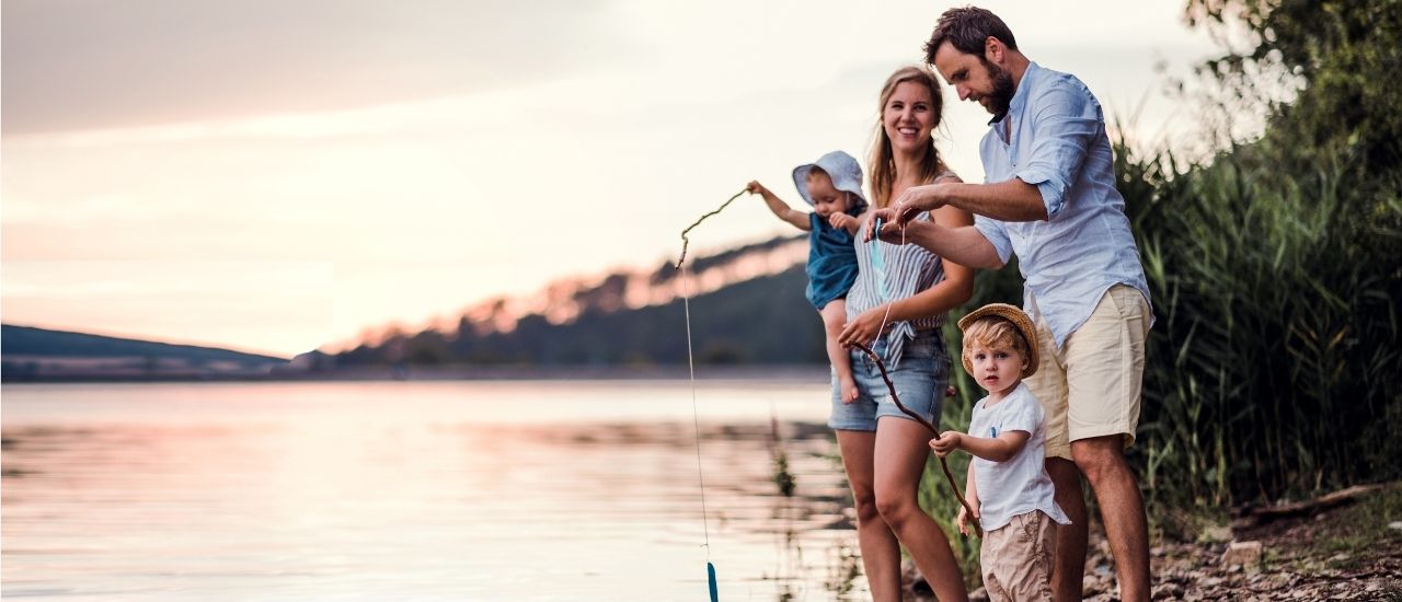Tributary family fishing on river shoreline