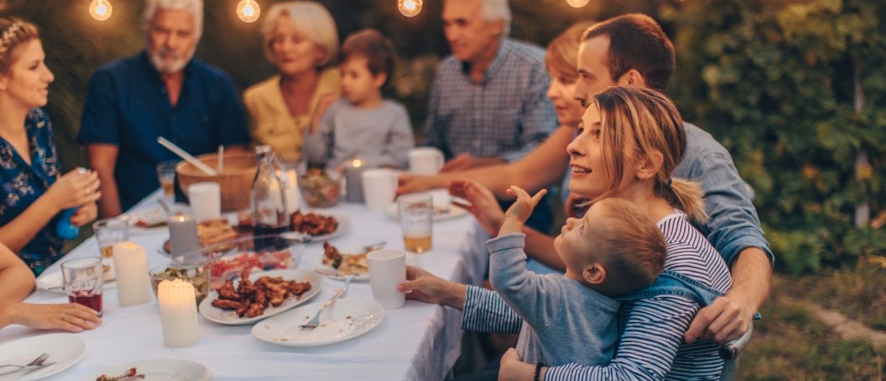 Family eating dinner outside at Tributary