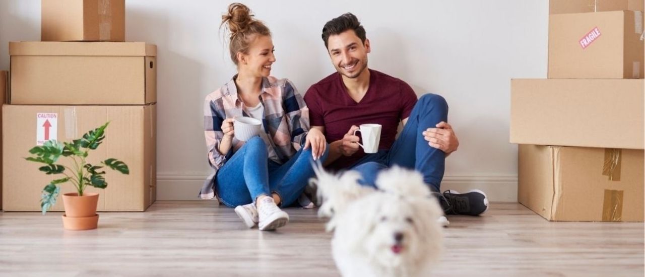 first-time homebuyers sitting on floor of new home