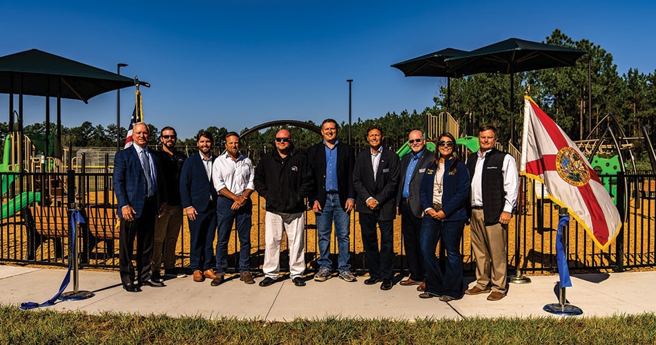 GreenPointe Developers standing in front of the playground at tributary regional park