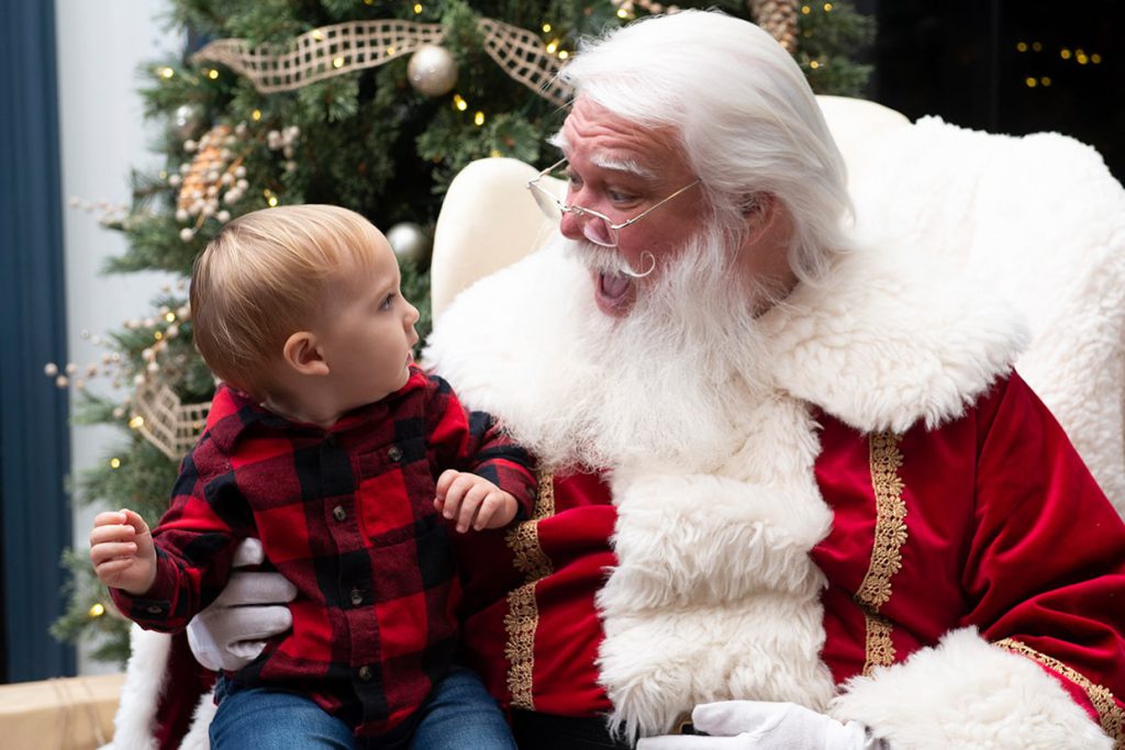 santa claus with boy at tributary community event