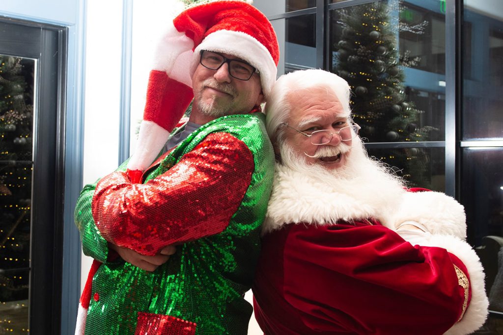 santa claus with man at tributary community event