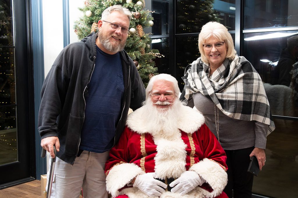 santa claus with couple at tributary community event