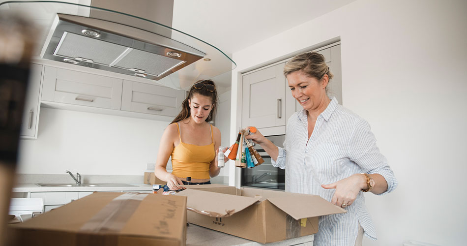 mother and daughter packing up in the kitchen