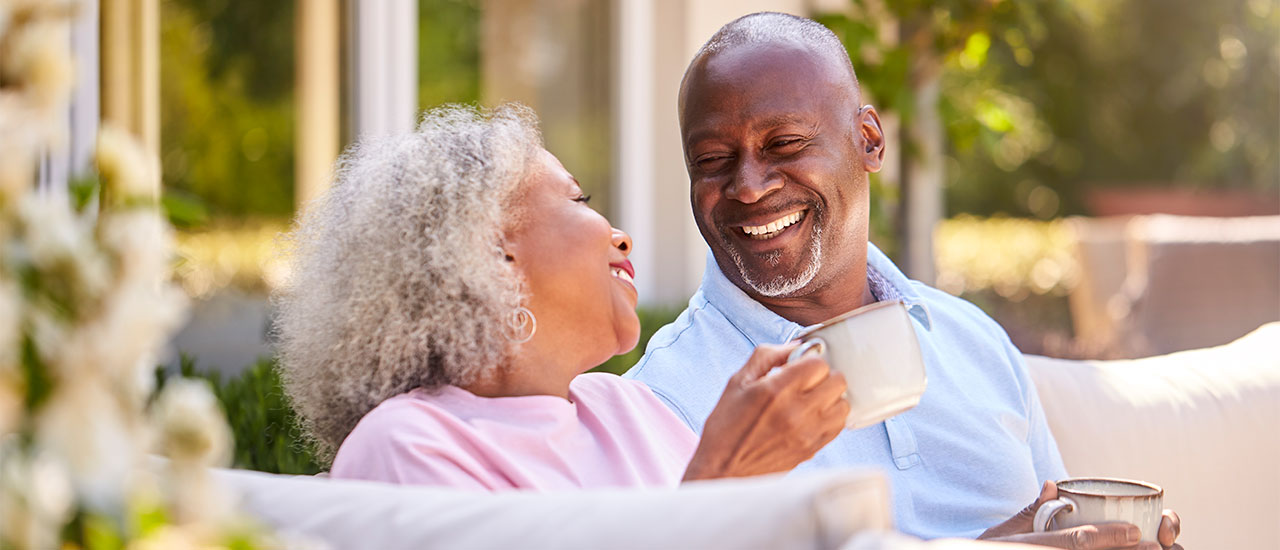 mature couple having coffee on patio
